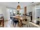 Modern farmhouse dining room with wooden table and view to the backyard at 1866 Hogan Ct, Castle Rock, CO 80109