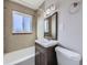 Clean bathroom with a single vanity, shower/tub combo and updated tile at 3259 N Adams St, Denver, CO 80205