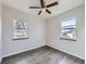 Bright bedroom with two windows, ceiling fan, and hardwood floors at 3259 N Adams St, Denver, CO 80205