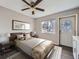 Bedroom with a queen bed, ceiling fan and exterior access at 3259 N Adams St, Denver, CO 80205