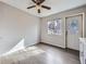 Bright bedroom with window, door, and ceiling fan at 3259 N Adams St, Denver, CO 80205