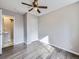 Bright bedroom with ceiling fan and grey wood-look floors at 3259 N Adams St, Denver, CO 80205