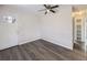 Open living area with wood floors, front door access, and a view into hallway at 3259 N Adams St, Denver, CO 80205