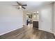 Bright living room with modern ceiling fan, wood floors, and view into kitchen at 3259 N Adams St, Denver, CO 80205