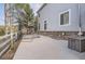 Spacious backyard with concrete patio, net, and partial brick wall at 10456 Carriage Club Dr, Lone Tree, CO 80124