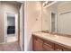 Bathroom featuring a vanity with tan tile countertops and access to other rooms at 10456 Carriage Club Dr, Lone Tree, CO 80124