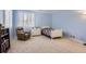 Comfortable bedroom with a twin bed, cozy armchair, and plenty of natural light at 10456 Carriage Club Dr, Lone Tree, CO 80124