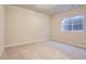 Neutral bedroom with beige carpet, painted walls, and a bright window at 10456 Carriage Club Dr, Lone Tree, CO 80124