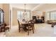 Elegant dining room with a formal table set, large windows and abundant natural light at 10456 Carriage Club Dr, Lone Tree, CO 80124