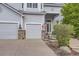Charming two-story home showcasing a 3-car garage, landscaped yard, and inviting entrance at 10456 Carriage Club Dr, Lone Tree, CO 80124
