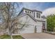 Charming two-story home showcasing a 3-car garage, landscaped yard, and inviting entrance at 10456 Carriage Club Dr, Lone Tree, CO 80124