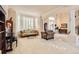 Inviting living room with large windows, plantation shutters and comfortable seating area at 10456 Carriage Club Dr, Lone Tree, CO 80124