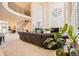 Spacious living room with high ceilings, fireplace, and a grand staircase leading to the second level at 10456 Carriage Club Dr, Lone Tree, CO 80124