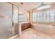 Relaxing main bathroom with a soaking tub, separate shower, and dual vanity sinks at 10456 Carriage Club Dr, Lone Tree, CO 80124