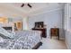 The spacious bedroom features large windows, a television, and a fireplace at 10456 Carriage Club Dr, Lone Tree, CO 80124