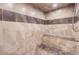 Elegant shower with multiple shower heads, a built-in bench, and decorative tile at 10456 Carriage Club Dr, Lone Tree, CO 80124