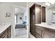 View of the Primary bathroom featuring a dark vanity and access to the bedroom at 330 High Point Dr # B102, Longmont, CO 80504