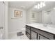 Bathroom featuring a dark vanity with sink, mirror, toilet and combination tub and shower at 330 High Point Dr # B102, Longmont, CO 80504