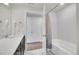 Bathroom with a dark vanity and tub/shower combination, walk-in closet and neutral walls at 330 High Point Dr # B102, Longmont, CO 80504