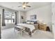 This spacious bedroom features neutral walls and carpeting, ceiling fan, bench and large window at 330 High Point Dr # B102, Longmont, CO 80504