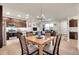 Open floorplan features a dining area near a modern kitchen, with a wooden table set and neutral decor at 330 High Point Dr # B102, Longmont, CO 80504