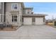 Beautiful gray home exterior with stone features and a two-car garage at 330 High Point Dr # B102, Longmont, CO 80504