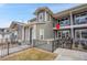 Exterior view of townhome features a fenced front yard and a balcony, enhancing curb appeal at 330 High Point Dr # B102, Longmont, CO 80504