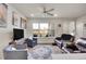 Bright living room with a ceiling fan, neutral walls, and an open view of the backyard at 330 High Point Dr # B102, Longmont, CO 80504