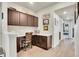 Home office features built-in dark wood cabinetry, white countertops, and hallway leading to a bedroom at 330 High Point Dr # B102, Longmont, CO 80504