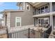 Charming front patio featuring cozy seating and a view of the landscaped garden with a wrought iron fence at 330 High Point Dr # B102, Longmont, CO 80504