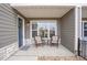 Cozy covered porch with wicker seating, offering a relaxing outdoor space by the front door at 330 High Point Dr # B102, Longmont, CO 80504