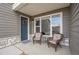 Inviting covered porch with wicker seating arrangement, enhancing the entryway of the home at 330 High Point Dr # B102, Longmont, CO 80504