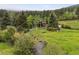 Beautiful home nestled among green trees with a stream, offering a serene landscape at 4230 S Meadow Brook Ln, Evergreen, CO 80439