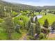 Scenic view of a home amidst lush greenery, creek, pond and natural beauty at 4230 S Meadow Brook Ln, Evergreen, CO 80439