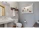 Charming bathroom with pedestal sink, decorative mirror, and unique wall accents at 4230 S Meadow Brook Ln, Evergreen, CO 80439