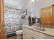 Bright bathroom featuring a colorful fish-themed shower curtain, wood cabinets, and modern vanity at 4230 S Meadow Brook Ln, Evergreen, CO 80439