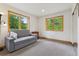 Comfortable bedroom with large windows, neutral carpeting, and ample natural light at 4230 S Meadow Brook Ln, Evergreen, CO 80439