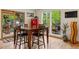 Bright dining area featuring hardwood floors, wooden table, and views of the outdoor greenery at 4230 S Meadow Brook Ln, Evergreen, CO 80439