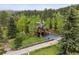 Stunning multi-story home with a sprawling deck and lush green surroundings at 4230 S Meadow Brook Ln, Evergreen, CO 80439