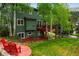 Two-story home features lush backyard with patio seating and landscaped yard at 4230 S Meadow Brook Ln, Evergreen, CO 80439
