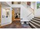 Inviting foyer featuring slate tile, convenient bench seating, and access to living spaces at 4230 S Meadow Brook Ln, Evergreen, CO 80439