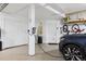 The bright and clean garage contains an EV charging station with plenty of room to park a car at 4230 S Meadow Brook Ln, Evergreen, CO 80439