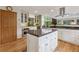 Spacious kitchen with a center island, stainless steel appliances, and beautiful wood flooring at 4230 S Meadow Brook Ln, Evergreen, CO 80439