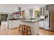 Bright kitchen featuring stainless steel appliances, custom cabinetry, and a center island at 4230 S Meadow Brook Ln, Evergreen, CO 80439