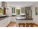 Charming kitchen with white cabinets, stainless steel appliances, and hardwood floors at 4230 S Meadow Brook Ln, Evergreen, CO 80439
