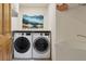 Functional laundry room equipped with washer, dryer, sink, and shelving for organization at 4230 S Meadow Brook Ln, Evergreen, CO 80439