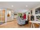 Open-concept living room with hardwood floors, fireplace, and views of the outdoors at 4230 S Meadow Brook Ln, Evergreen, CO 80439