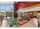 Spacious living room with a fireplace, hardwood floors, large windows, and open floor plan at 4230 S Meadow Brook Ln, Evergreen, CO 80439