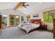 Spacious main bedroom with vaulted ceiling, balcony access, and beautiful greenbelt views at 4230 S Meadow Brook Ln, Evergreen, CO 80439