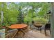 Expansive deck with outdoor seating, grill, and views of the surrounding greenery and landscape at 4230 S Meadow Brook Ln, Evergreen, CO 80439